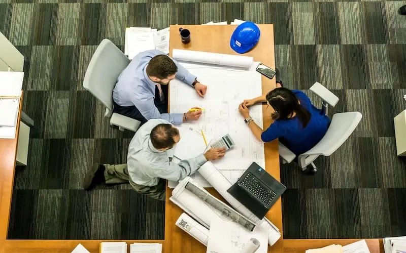 People around a table trying to solve problems