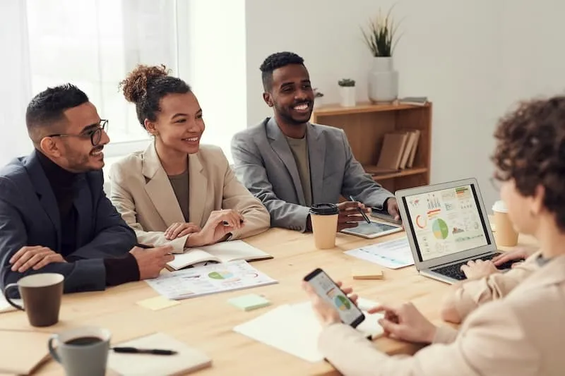 People at a table smiling in conversation